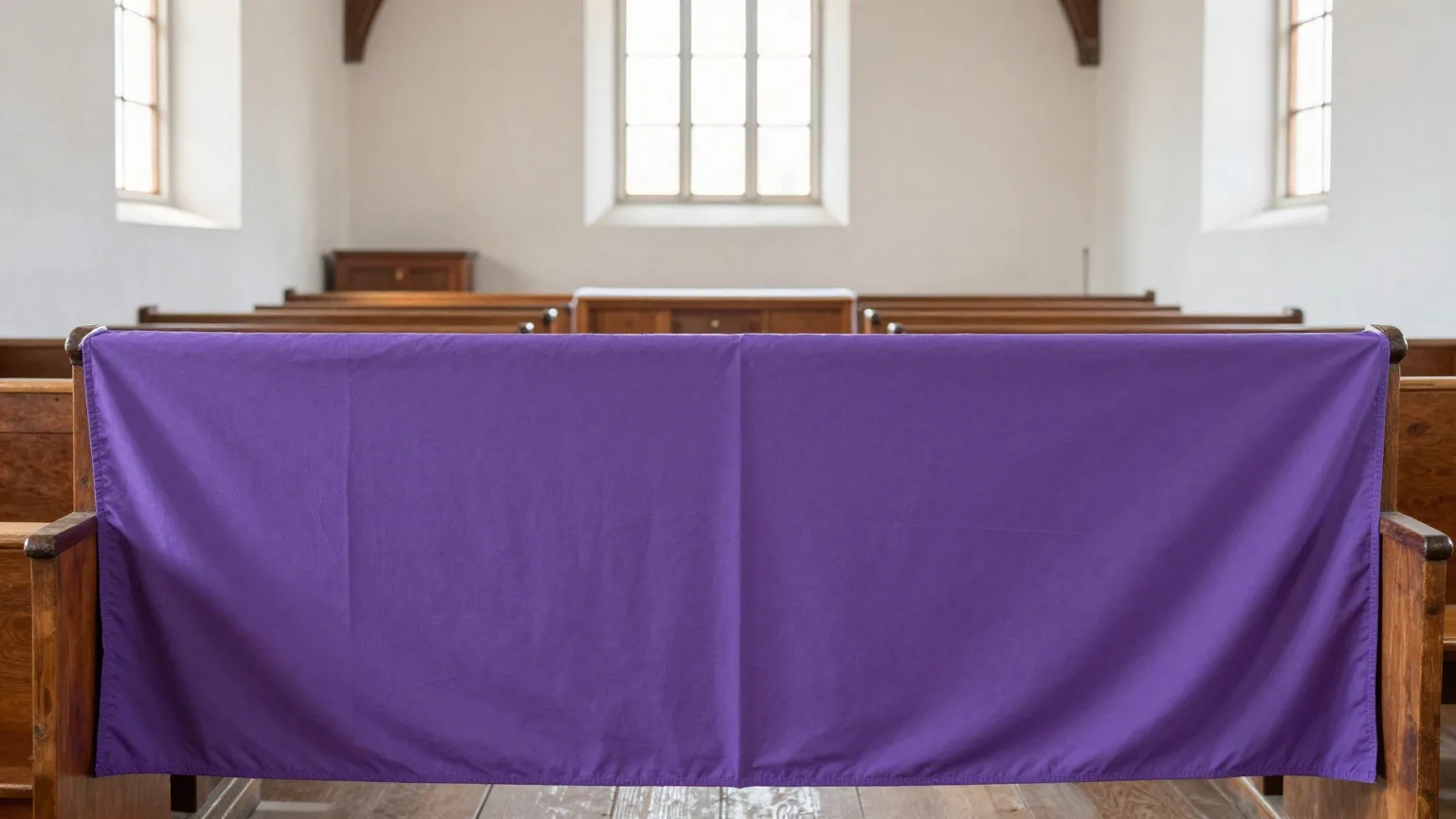 Schlichtes violettes Fastentuch vor dem Altarraum einer Dorfkirche im Frühlingslicht
